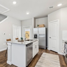 kitchen with ample counter-space, modern appliances and bright lighting