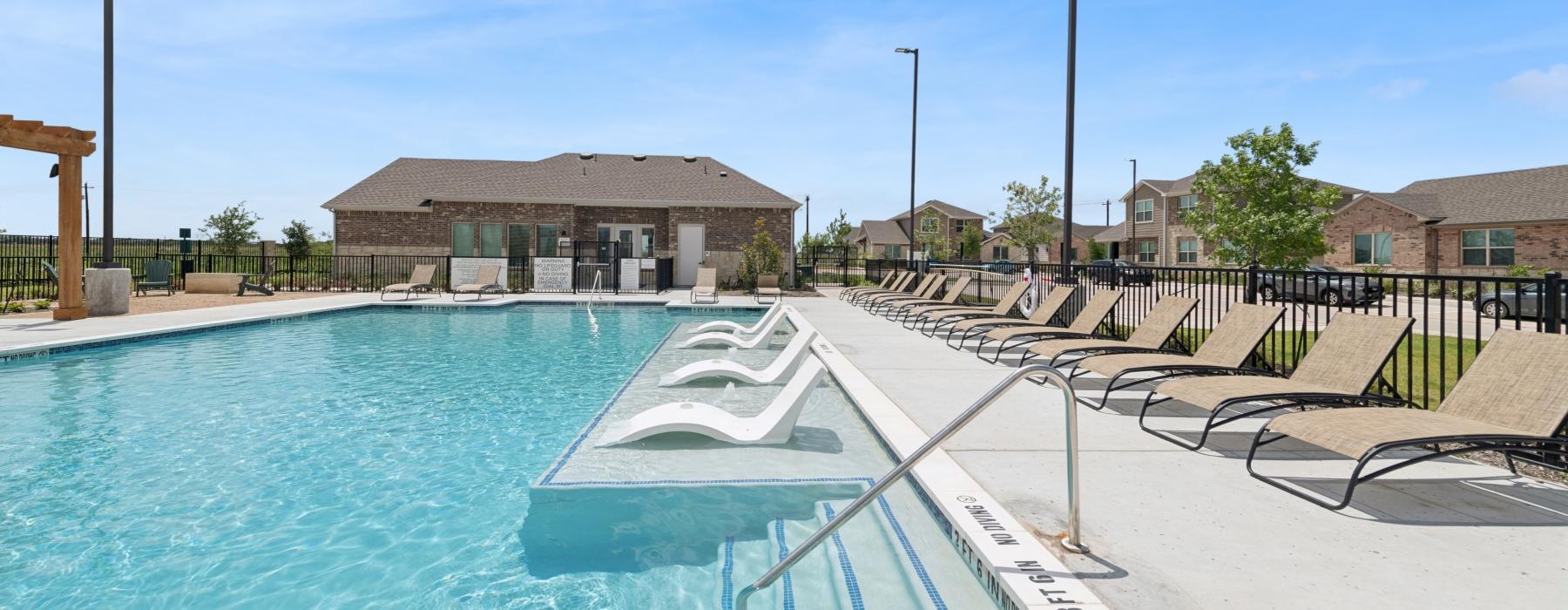 a swimming pool with a building in the background