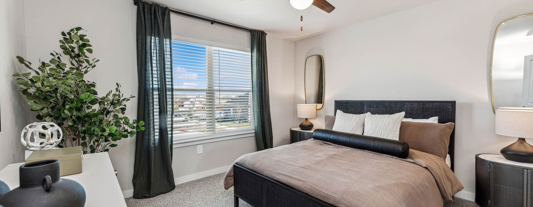 a bedroom with a bed and a plant