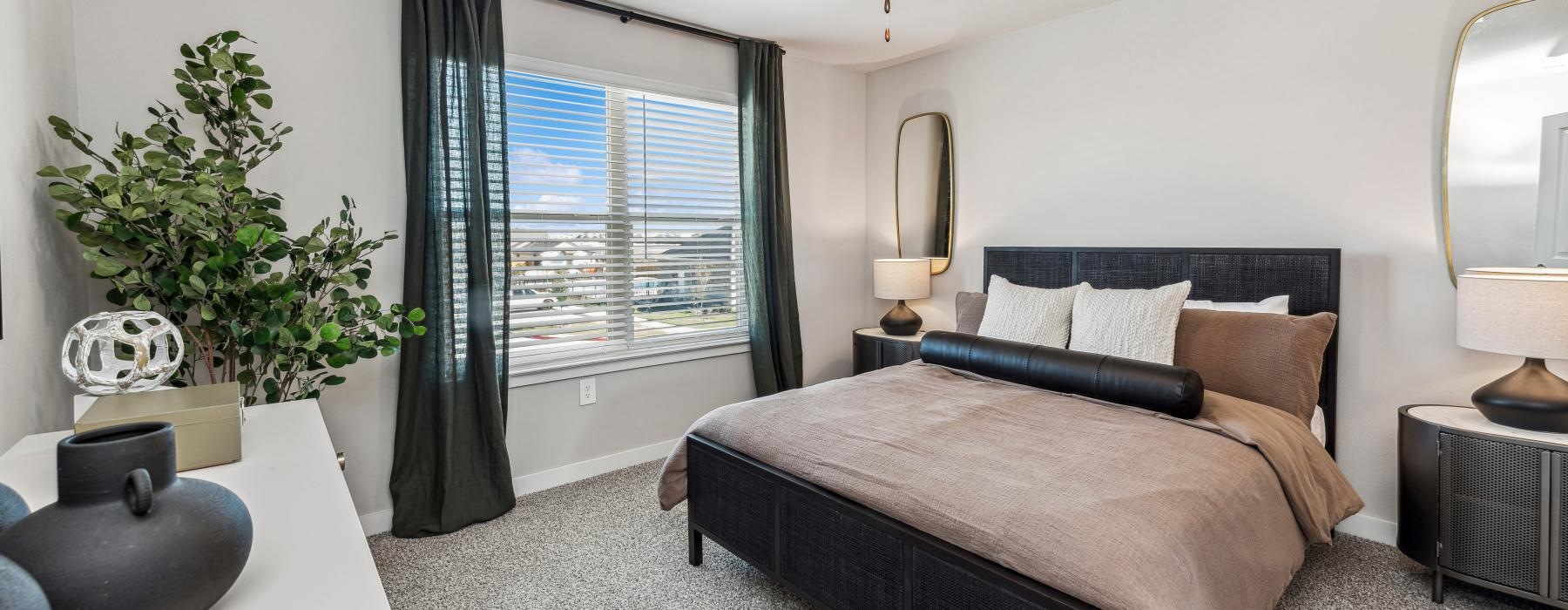 a bedroom with a bed and a plant